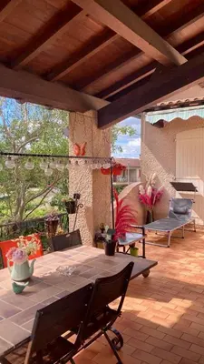 a patio with a table and chairs on a patio at Chambre au calme in Lagarrigue