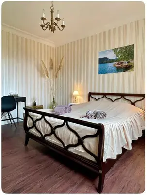 a bedroom with a large bed with a chandelier at Chambre au calme in Lagarrigue