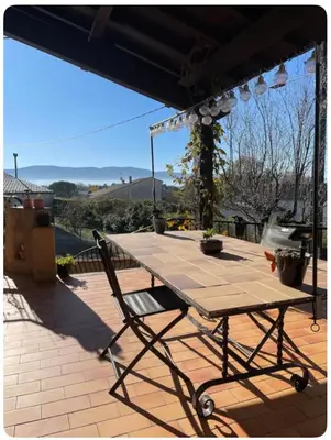 a picnic table on top of a patio at Chambre au calme in Lagarrigue