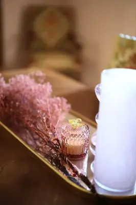 a tray with a cupcake and a candle on a table at Gîte Les Tilleuls in Lautrec