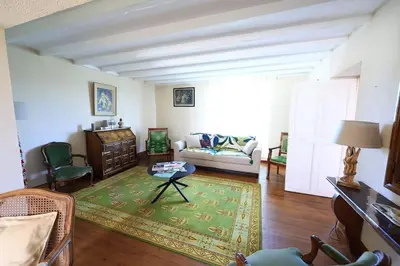 a living room with a couch and a table at Gîte Les Tilleuls in Lautrec