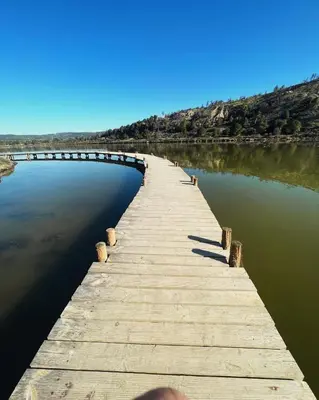 a wooden bridge over a body of water at Appartement 1 chambre in Peyriac-de-Mer
