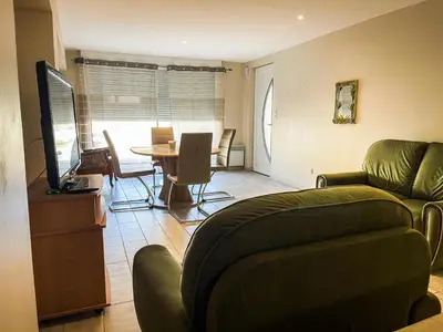 a living room with a couch and a table at Appartement 1 chambre in Peyriac-de-Mer