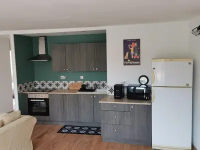 a kitchen with a white refrigerator in a room at Le gîte de Melly in Bélesta