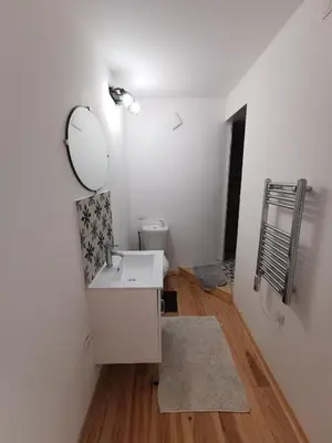 a bathroom with a white sink and a mirror at Le gîte de Melly in Bélesta