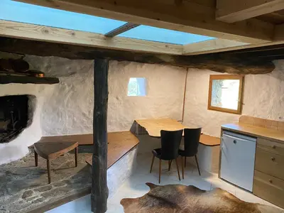 a kitchen with a table and chairs in a cabin at La bergerie des étoiles in Rouvenac