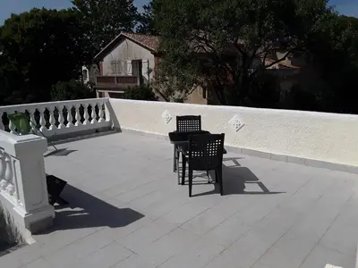 two chairs and a table on a patio at Grand studio au milieu des vignes in Moussan