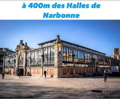 a large building with people walking in front of it at Studio Cosy Climatisé Centre Ville faites tout à Pied in Narbonne