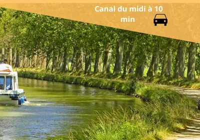 a boat on a river with trees in the background at L'évasion Carcassonnais avec Terrasse 2 places de Parking privée in Carcassonne