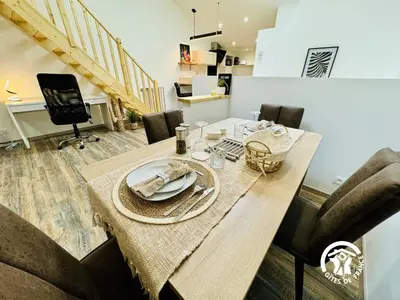 a dining room with a wooden table and chairs at La detente in Lézignan-Corbières