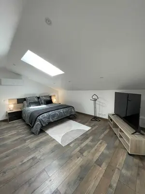 a bedroom with a bed and a flat screen tv at La detente in Lézignan-Corbières