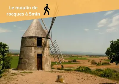an image of a windmill with a man walking on it at Le cocon centre ville au calme Oc Keys 34 in Castelnaudary