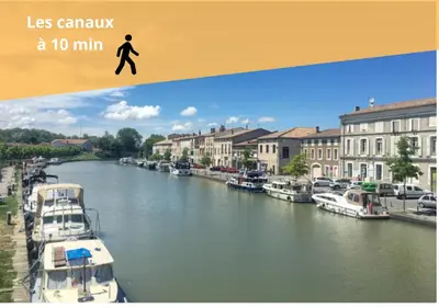 a picture of a river with boats in the water at Le cocon centre ville au calme Oc Keys 34 in Castelnaudary