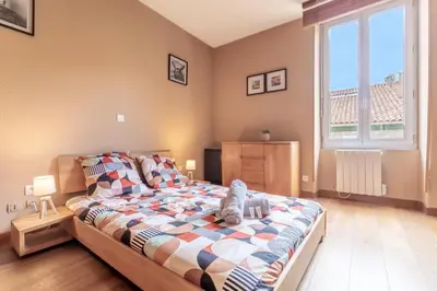 a bedroom with a bed with a stuffed animal on it at Hypercentre - Proche Parking Gratuit - Fibre - Calme in Narbonne