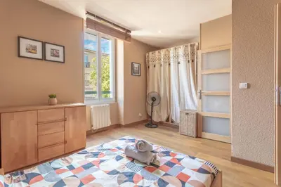 a bedroom with a stuffed animal sitting on a bed at Hypercentre - Proche Parking Gratuit - Fibre - Calme in Narbonne