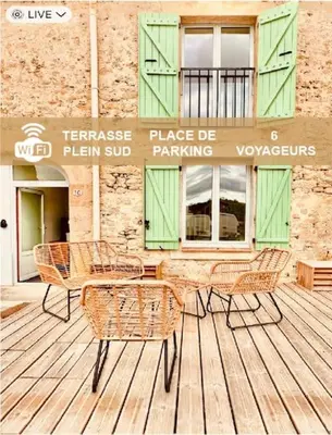 a group of chairs and tables on a wooden deck at Pierre Lauragaise in Avignonet-de-Lauragais