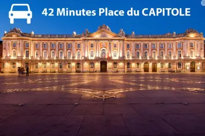 a large building at night with the words minutes place du capitol at Pierre Lauragaise in Avignonet-de-Lauragais