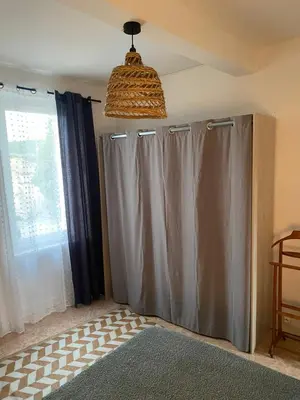 a room with gray curtains and a window at Casa Bohème in Saint-Jean-de-Barrou
