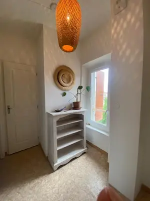 a room with a shelf and a window and a chandelier at Casa Bohème in Saint-Jean-de-Barrou