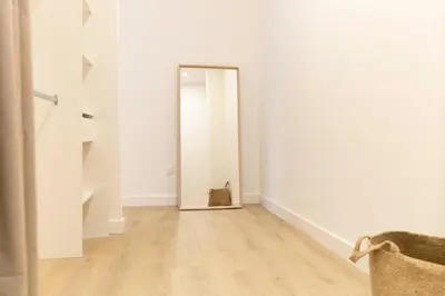 a mirror in an empty room with a cat sitting in it at Olivier ATTON in Narbonne