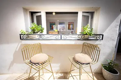 a couple of chairs sitting in front of a window at Carcassonne Epicerie in Carcassonne