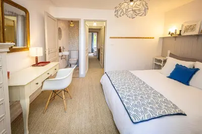 a hotel room with a bed and a desk and a desk at Carcassonne Epicerie in Carcassonne