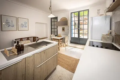 a kitchen with a large sink and a table at Carcassonne Epicerie in Carcassonne
