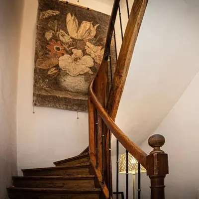 a painting of flowers on the wall next to a staircase at Carcassonne Epicerie in Carcassonne