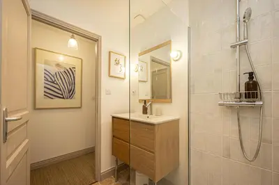 a bathroom with a shower and a sink and a mirror at Carcassonne Epicerie in Carcassonne