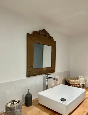 a bathroom with a white sink and a mirror at Maison Jasmin in Gruissan