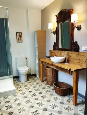 a bathroom with a sink and a toilet at La 21 avenue des Corbières in Durban-Corbières