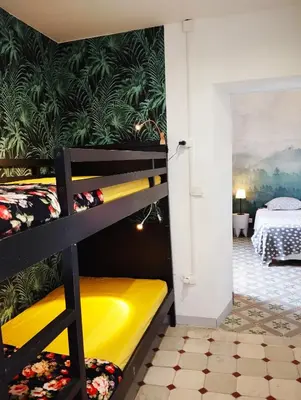 a bunk bed in a room with a bedroom at La 21 avenue des Corbières in Durban-Corbières