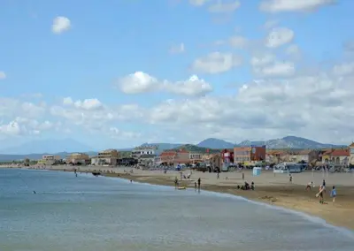a group of people on a beach near the water at Mimi in Port-la-Nouvelle