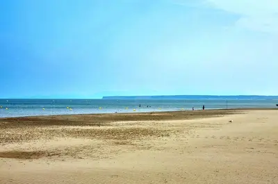 a beach with people swimming in the water at Mimi in Port-la-Nouvelle
