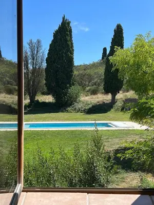 a view of a swimming pool from a window at Villa Kiener in Villeneuve-la-Comptal