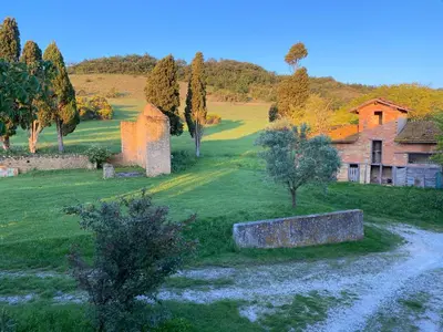 an old building and a field with trees and a house at Villa Kiener in Villeneuve-la-Comptal