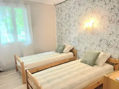 a room with two beds and a window at Evasion en Occitanie in Mailhac