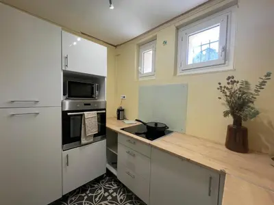 a kitchen with a counter with a sink and a microwave at Evasion en Occitanie in Mailhac