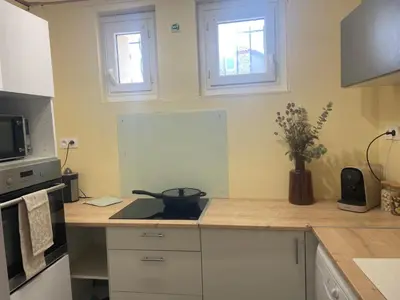 a kitchen with a counter with a bowl on a stove at Evasion en Occitanie in Mailhac