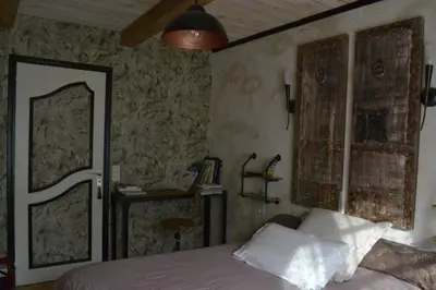 a bedroom with a bed and a window and a door at Occit'Homières in Saint-Pons