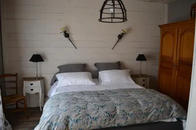 a bedroom with a large bed with two pillows at Occit'Homières in Saint-Pons
