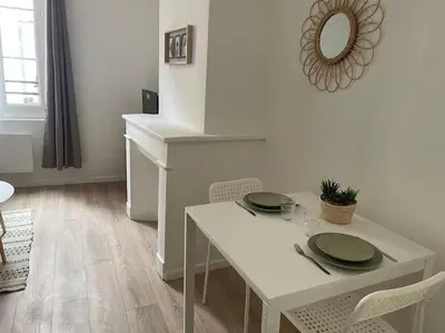 a white table with green plates on it in a room at L'entre Stud' in Castres