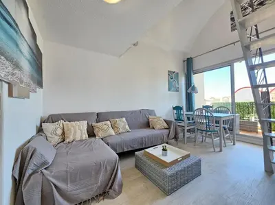 a table with two chairs and a blue table and chairs at Joli & Cosy ! 4 Personnes in Gruissan