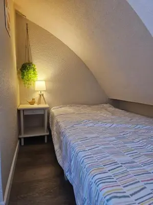 a bedroom with two beds and a table with a lamp at Joli & Cosy ! 4 Personnes in Gruissan