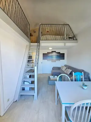 a patio with three chairs and a table on a balcony at Joli & Cosy ! 4 Personnes in Gruissan