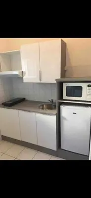 a kitchen with a sink and a microwave at Appartement port GRUISSAN in Gruissan