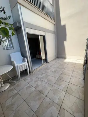 a patio with a window and a table and a chair at Appartement port GRUISSAN in Gruissan