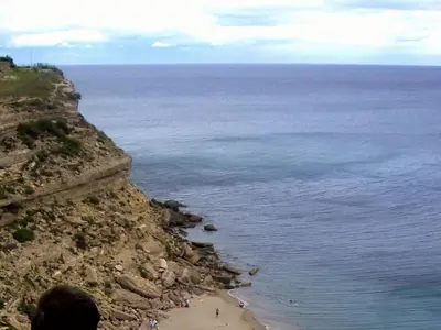 a person standing on top of a cliff overlooking a beach at Lo Cantou Comfortable holiday residence in Camplong-dʼAude