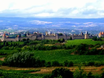 a castle on top of a green field at Lo Cantou Comfortable holiday residence in Camplong-dʼAude