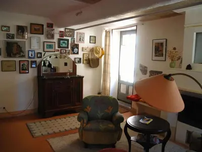 a living room with a chair and a lamp at Lo Cantou Comfortable holiday residence in Camplong-dʼAude